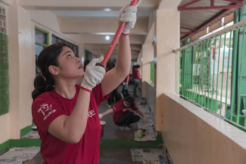 Brigada Eskwela painting the classroom ceiling