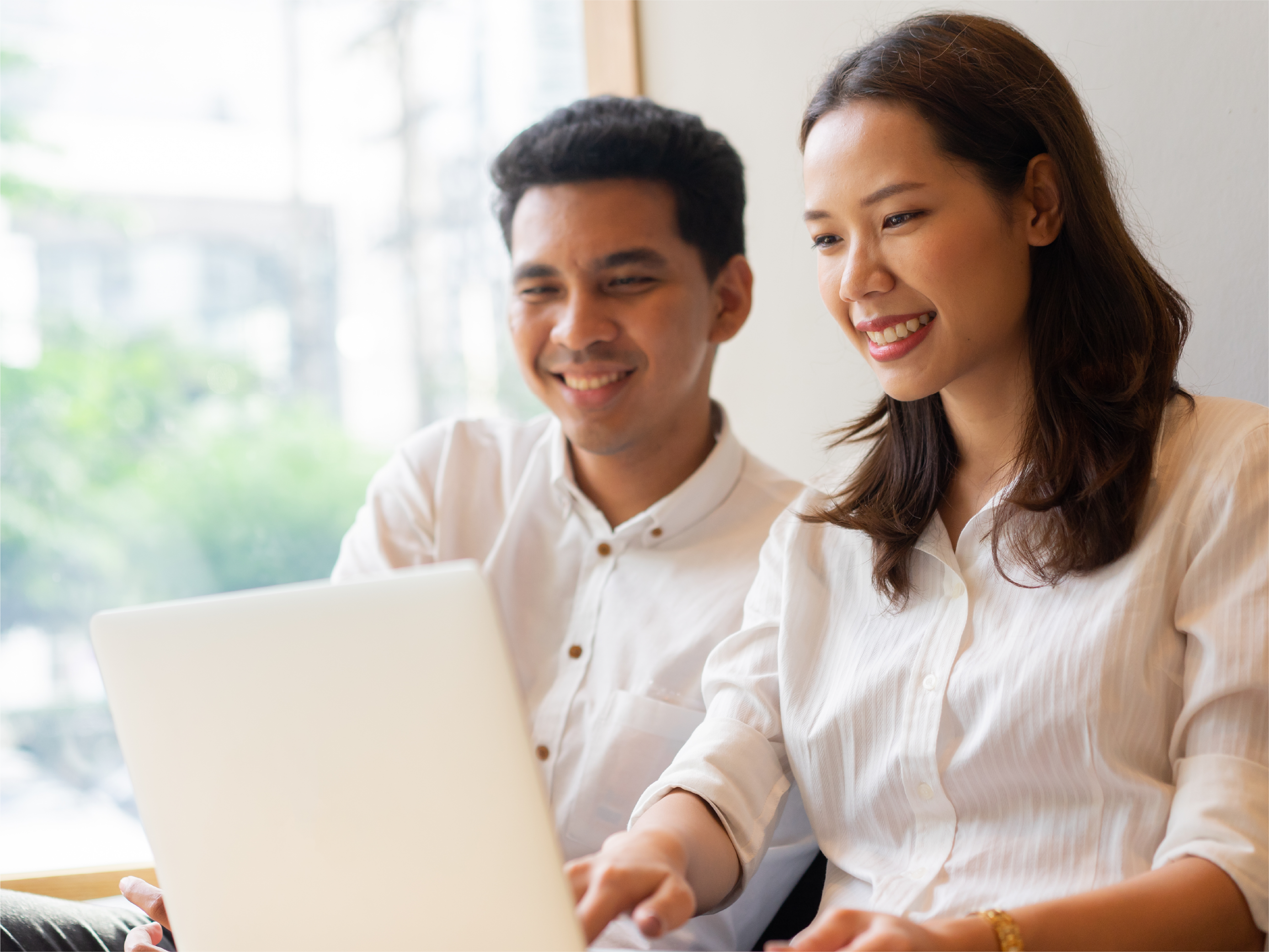A couple looking at the laptop together
