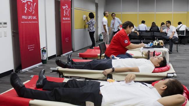 Red Cross staff taking blood