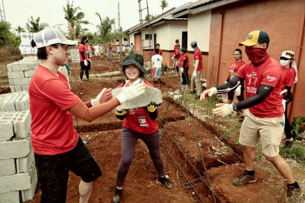 Volunteers passing construction materials