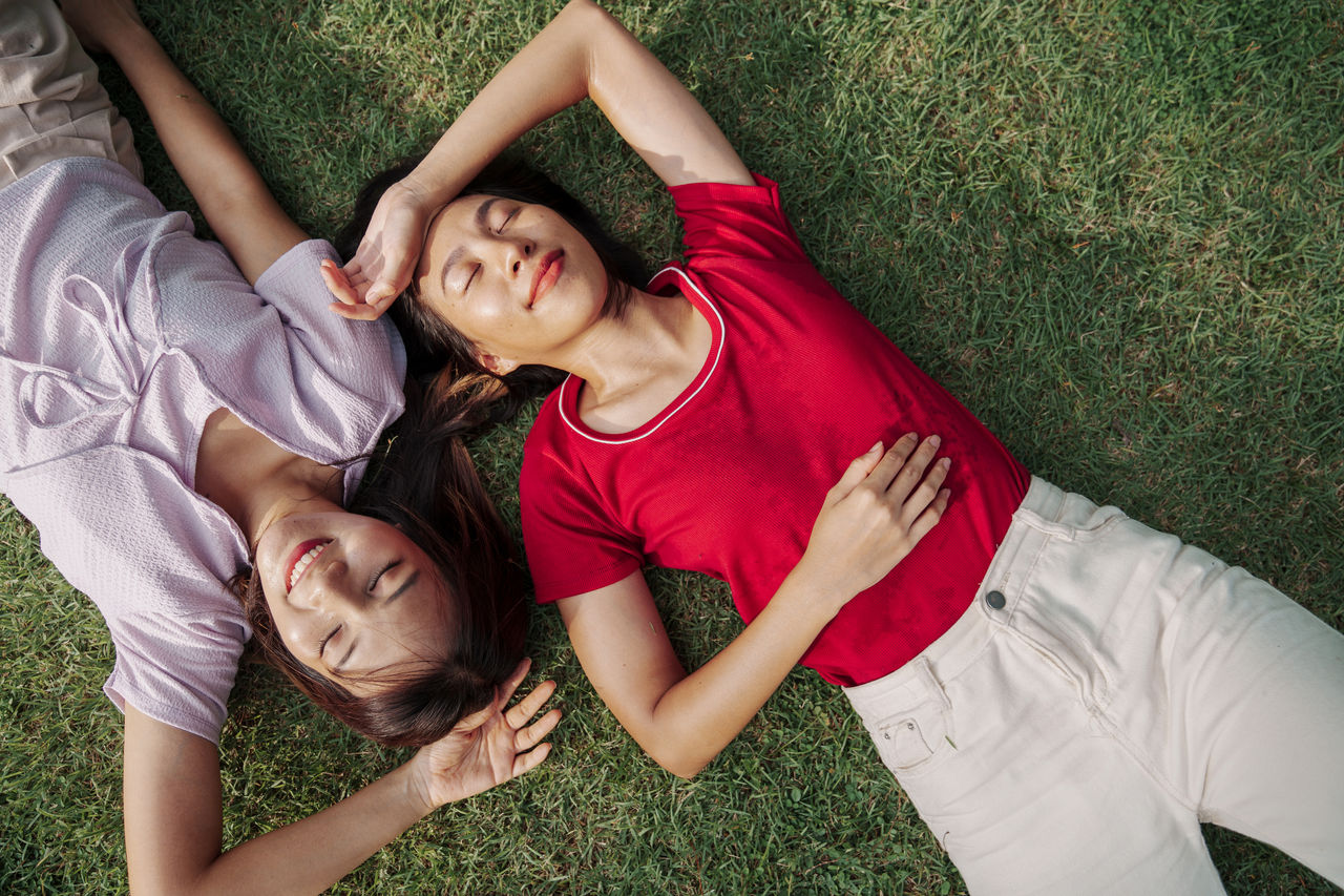 Friends lying down on the grass