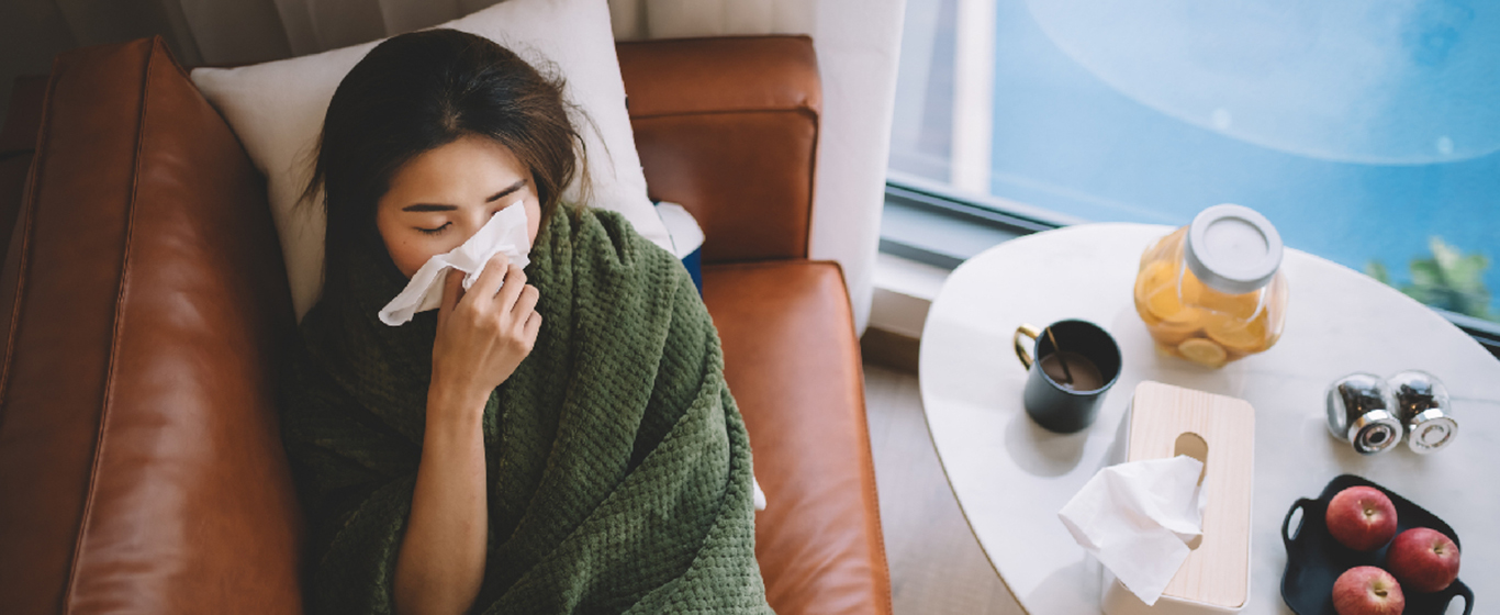 sick woman lying down in her couch