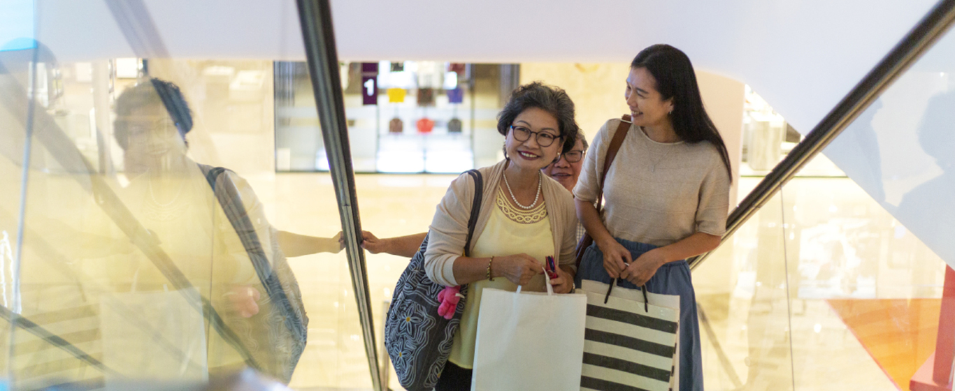 Woman shopping white in an escalator