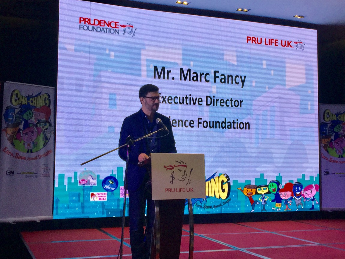 Marc delivering speech at the Cha-Ching conference