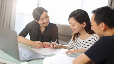 A couple signing forms