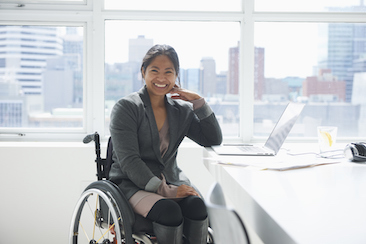 A smiling woman in a wheelchair