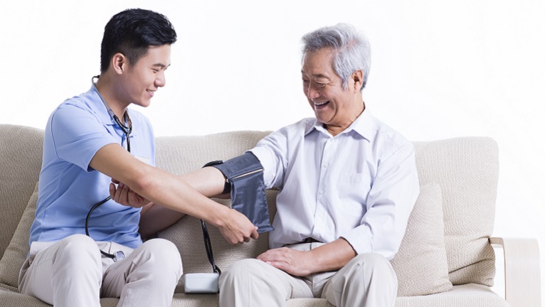 Doctor checking patient’s blood pressure