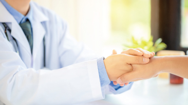 Doctor holding a patients hand