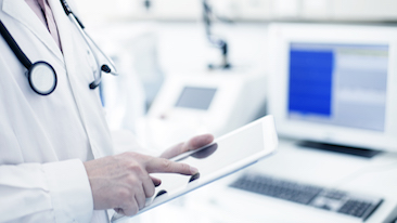 A doctor using a tablet