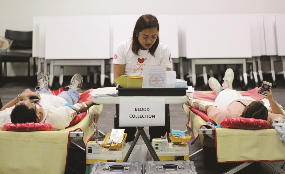 Two women lying down and donating blood