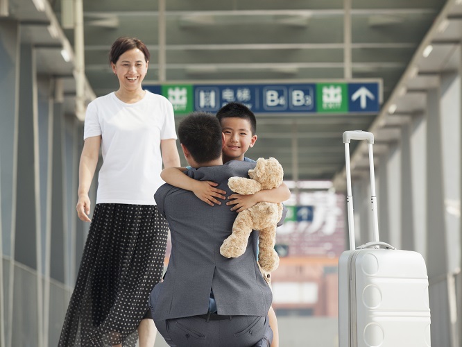 Father greeting his family at the airport