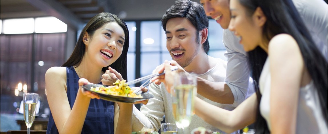 Friends having a good time eating in a restaurant