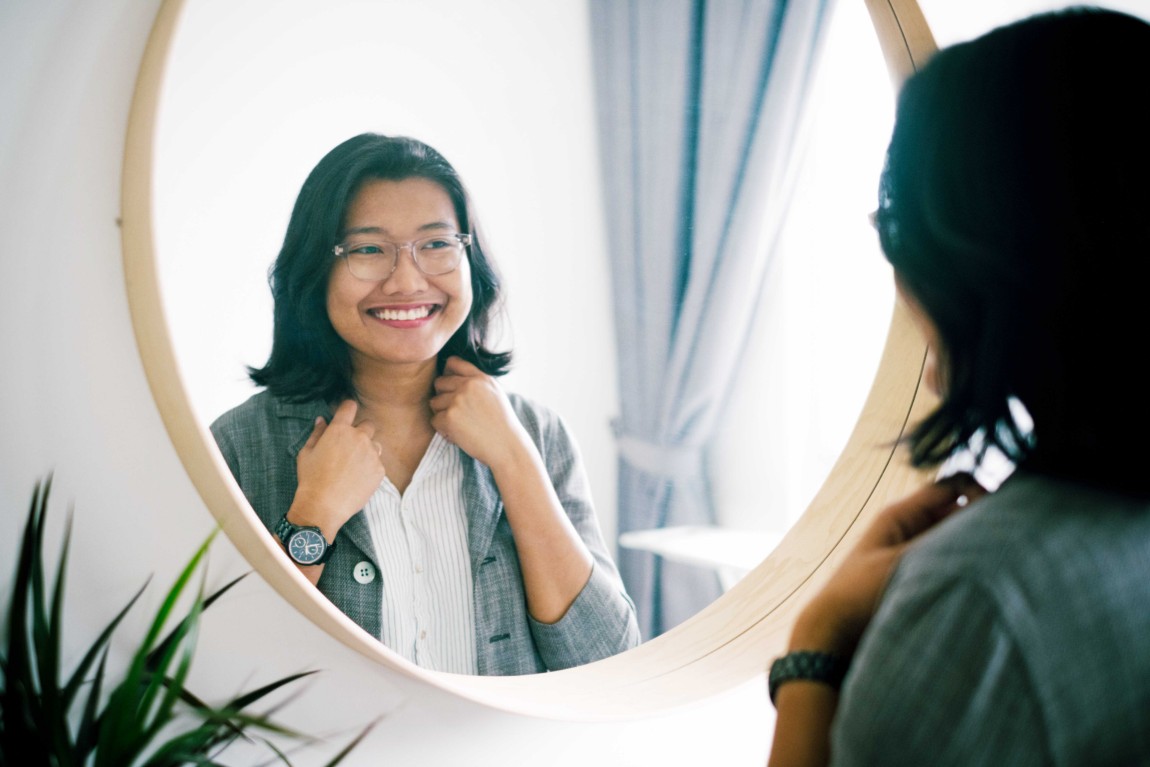 Woman checking her reflection on a mirror