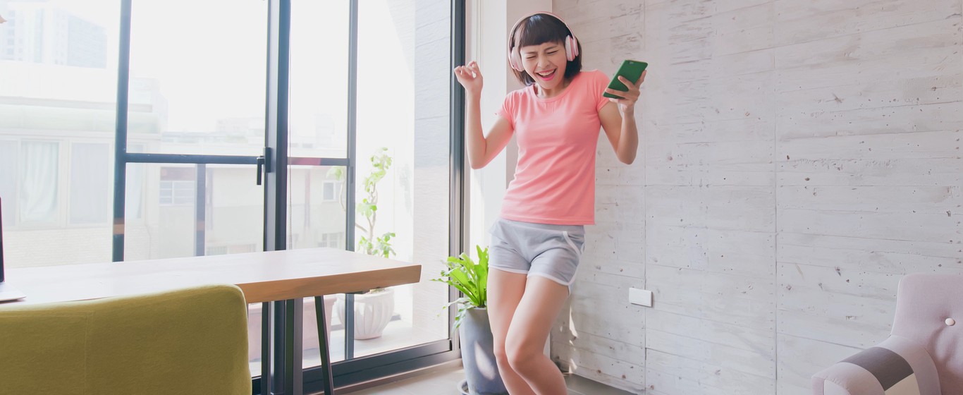 Girl dancing while wearing headphones