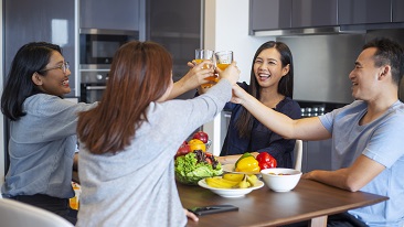 Happy friends toasting to healthy food