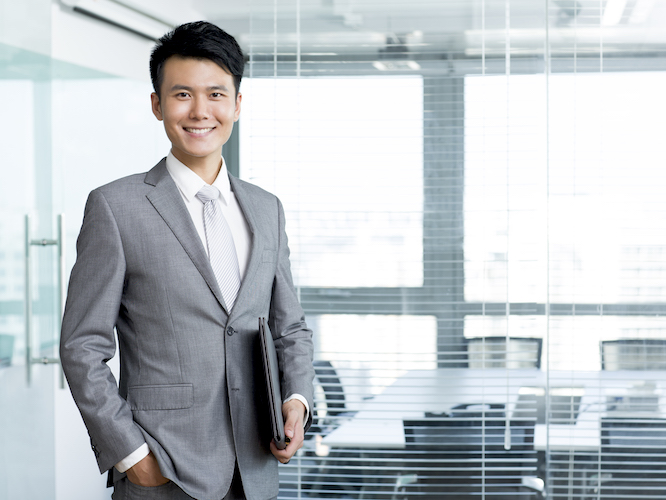 Man in a business suit holding a folder