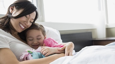 Mother hugging daughter