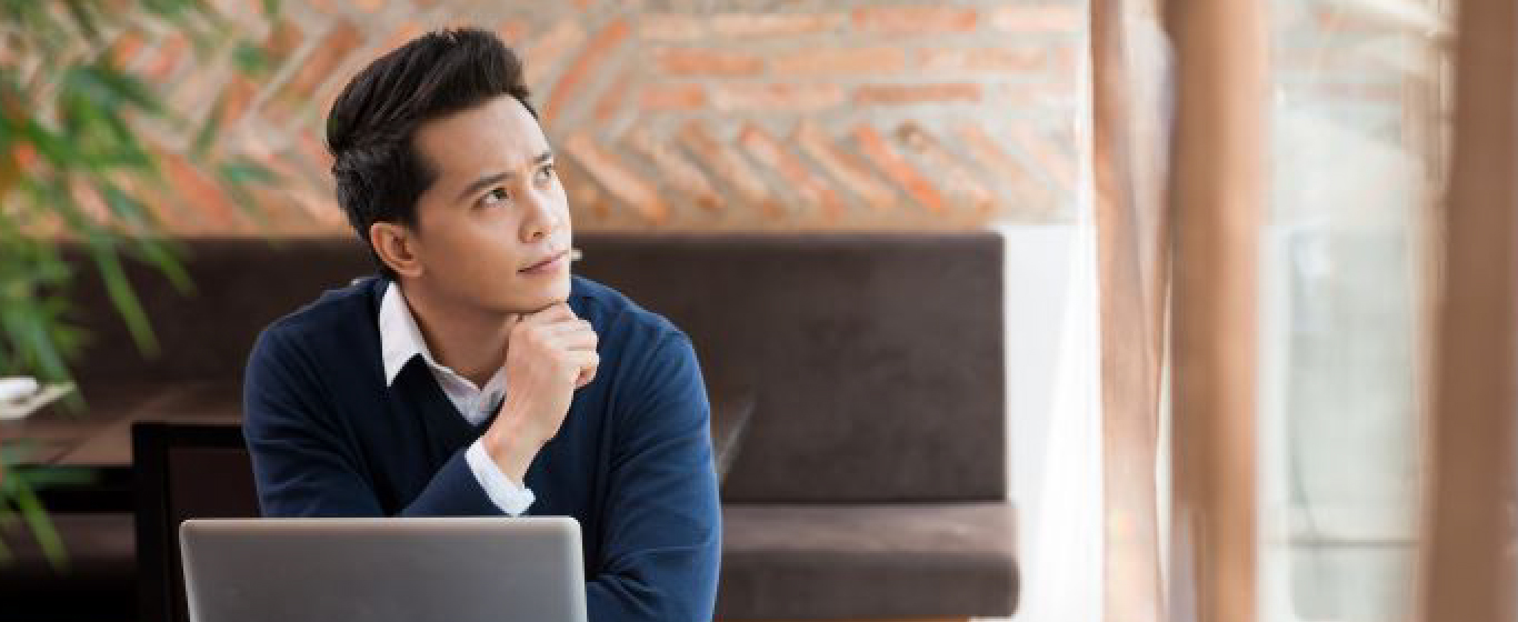 Person with laptop thinking