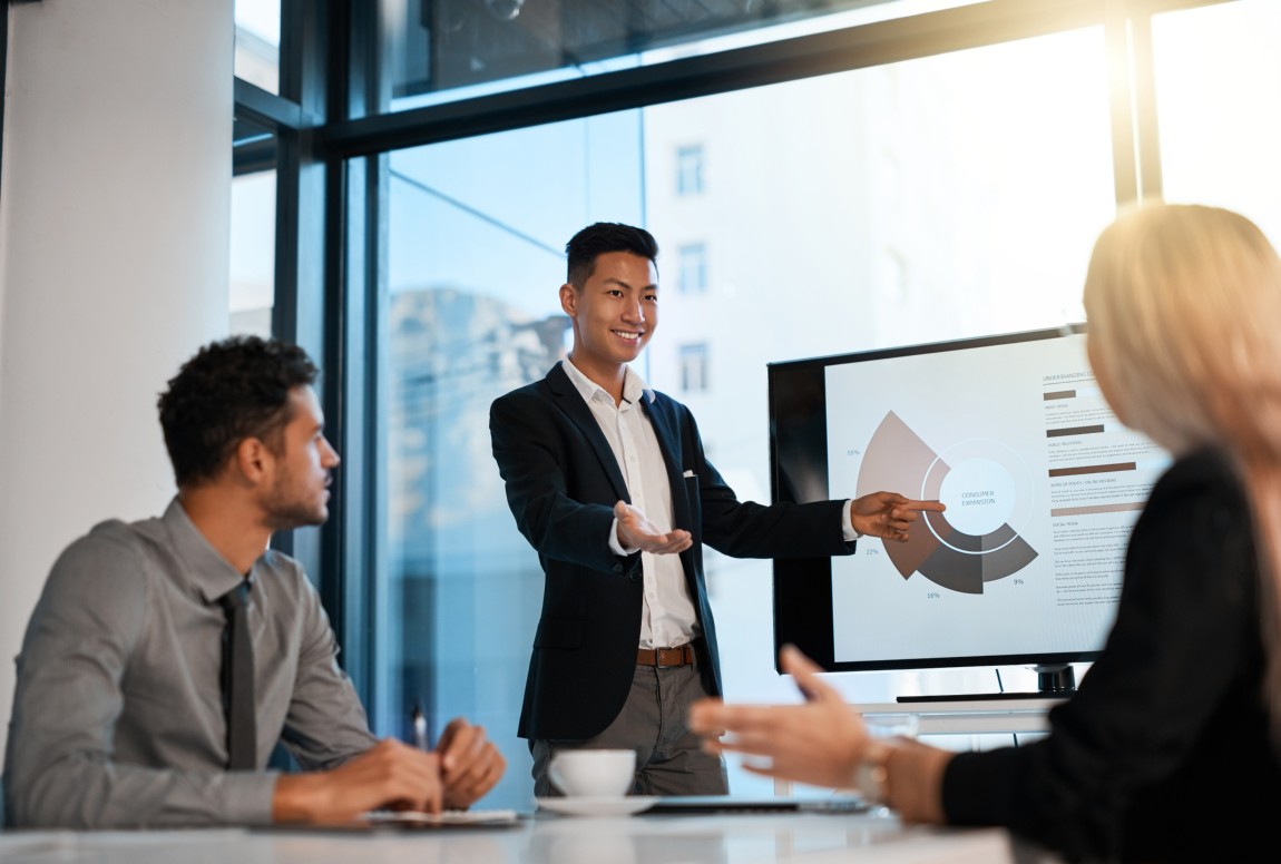 A person presenting business performance to colleagues.
