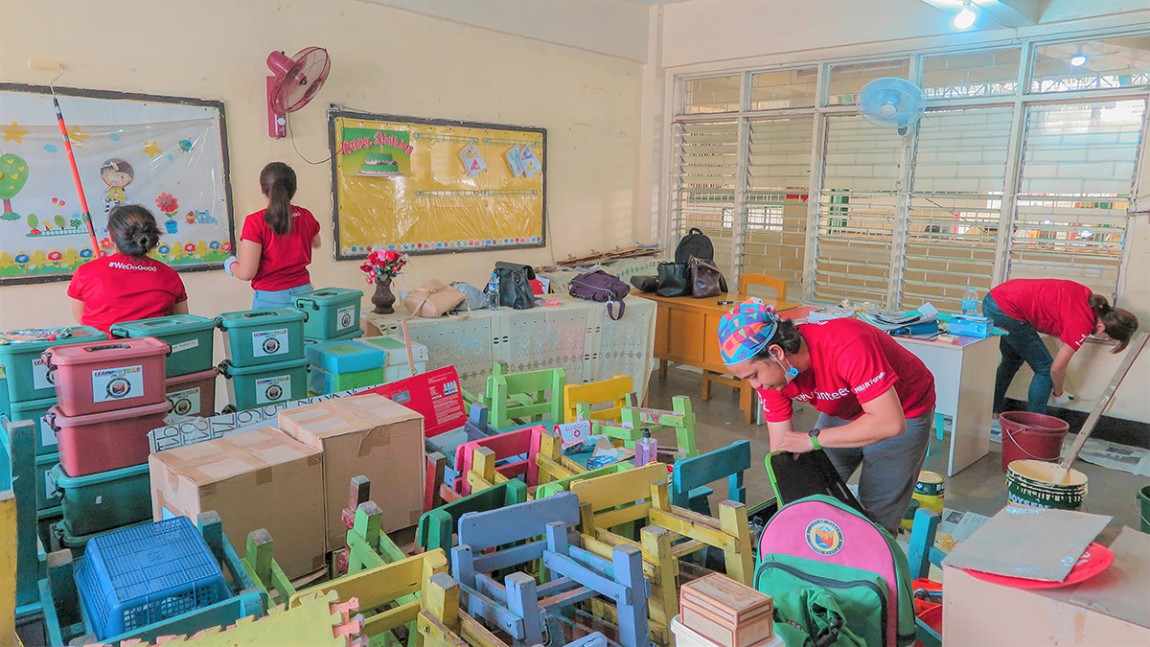 People cleaning up a classroom