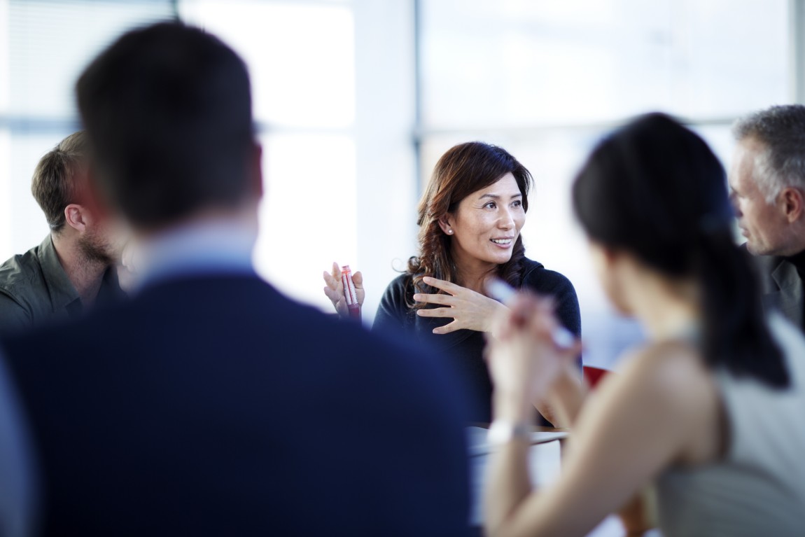 A team having a discussion inside a meeting room.