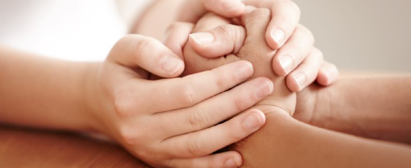 Two people holding each others hands
