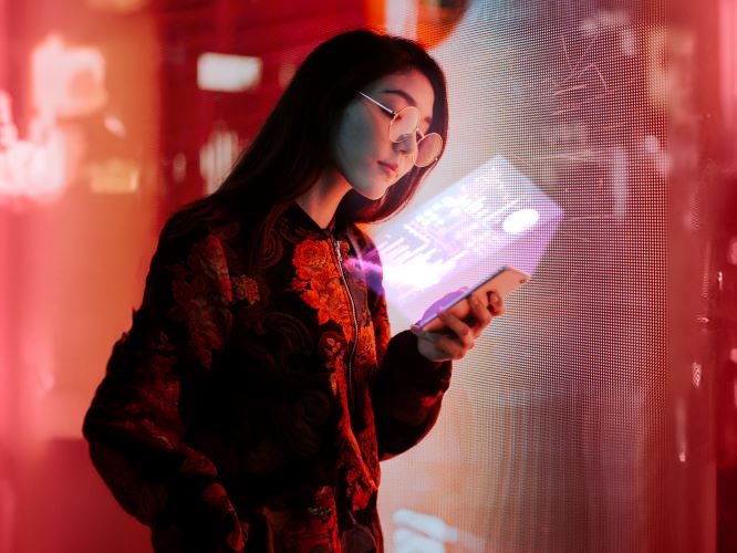 Woman analyzing tech stocks with her mobile phone