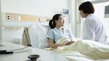 A doctor attending to her confined patient