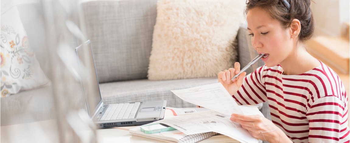 A woman sorting her bills