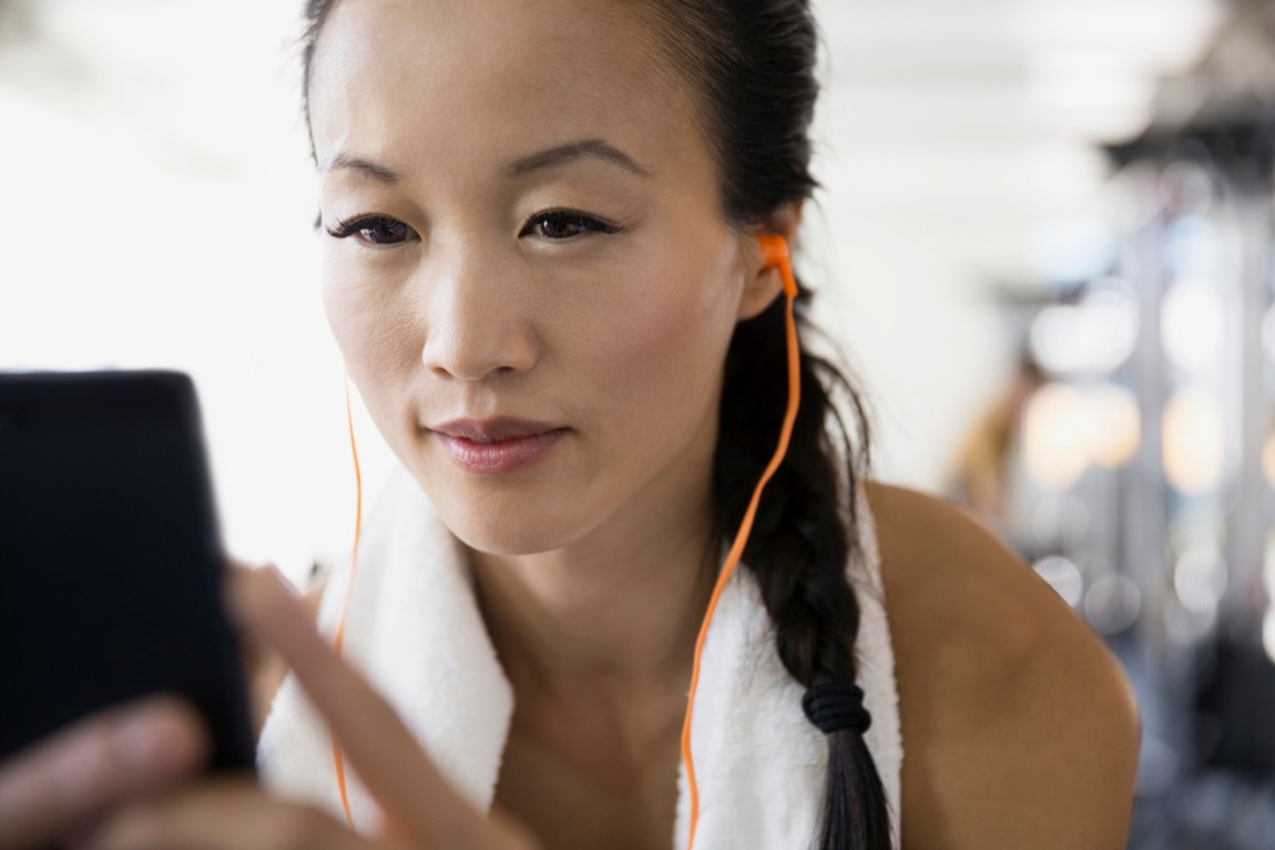 Woman using phone at the gym