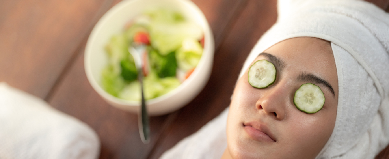Woman with cucumber on eyes